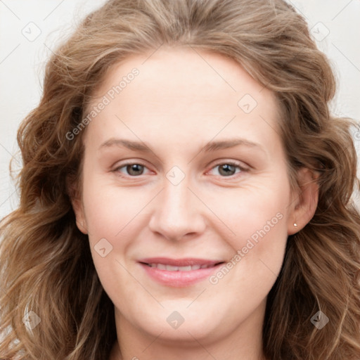 Joyful white young-adult female with long  brown hair and blue eyes