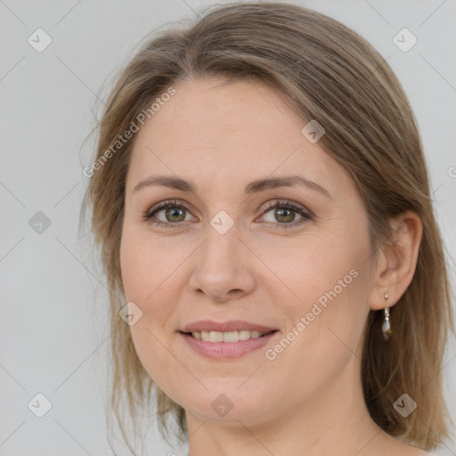 Joyful white adult female with medium  brown hair and grey eyes