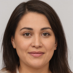 Joyful white adult female with medium  brown hair and brown eyes