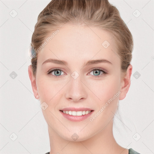 Joyful white young-adult female with long  brown hair and blue eyes