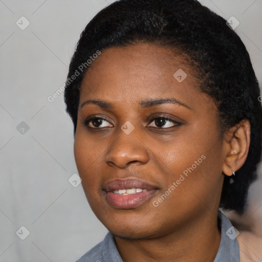 Joyful black young-adult female with short  black hair and brown eyes