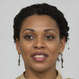 Joyful black young-adult female with short  brown hair and brown eyes