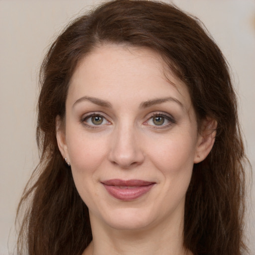 Joyful white young-adult female with long  brown hair and grey eyes