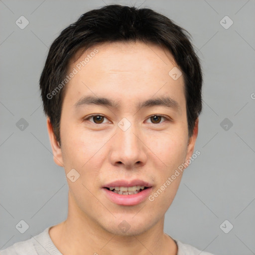 Joyful asian young-adult male with short  brown hair and brown eyes