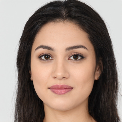 Joyful latino young-adult female with long  brown hair and brown eyes