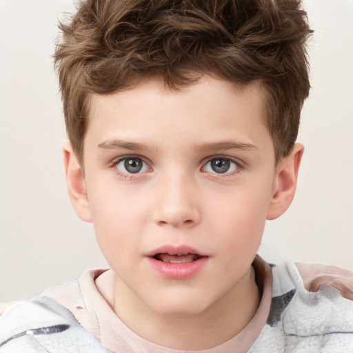 Joyful white child male with short  brown hair and brown eyes