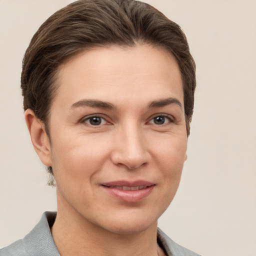 Joyful white young-adult female with short  brown hair and grey eyes