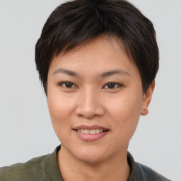 Joyful asian young-adult female with short  brown hair and brown eyes