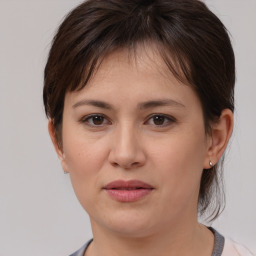 Joyful white young-adult female with medium  brown hair and brown eyes