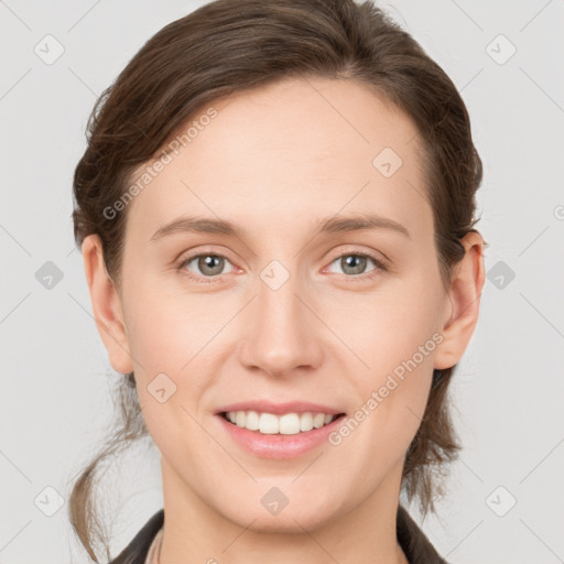 Joyful white young-adult female with medium  brown hair and grey eyes