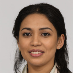 Joyful latino young-adult female with long  brown hair and brown eyes