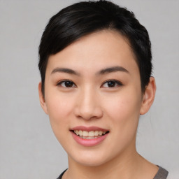 Joyful asian young-adult female with short  brown hair and brown eyes