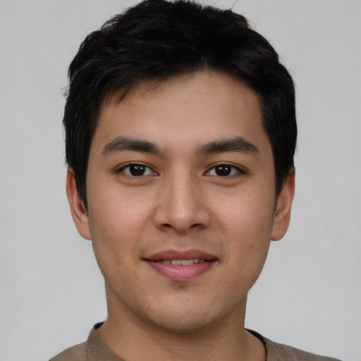 Joyful asian young-adult male with short  black hair and brown eyes