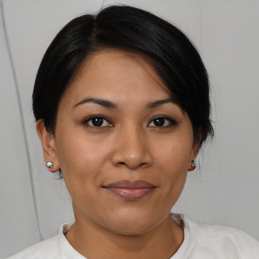 Joyful latino young-adult female with short  brown hair and brown eyes
