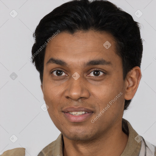 Joyful black young-adult male with short  black hair and brown eyes