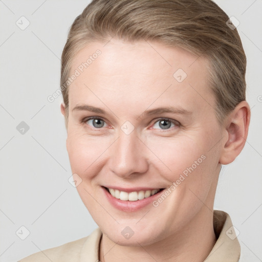 Joyful white young-adult female with short  brown hair and grey eyes