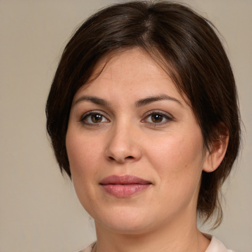 Joyful white young-adult female with medium  brown hair and brown eyes