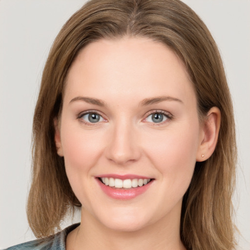 Joyful white young-adult female with long  brown hair and blue eyes