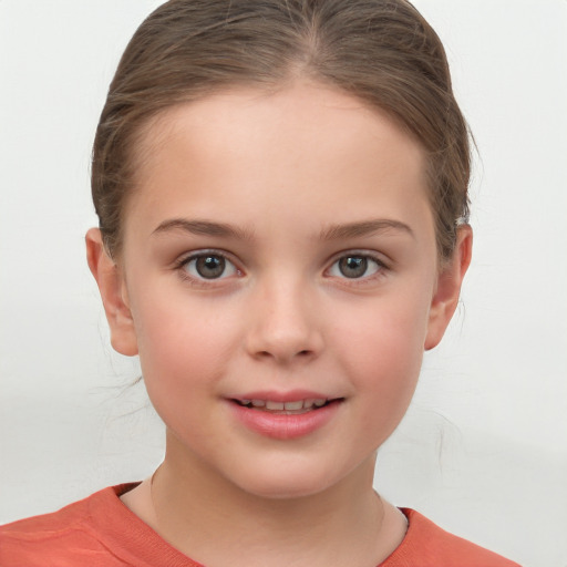 Joyful white child female with short  brown hair and grey eyes