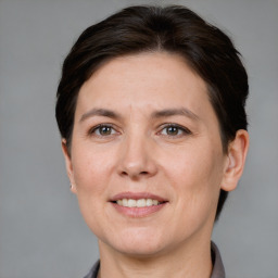 Joyful white adult female with short  brown hair and brown eyes