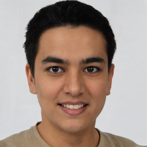 Joyful white young-adult male with short  black hair and brown eyes