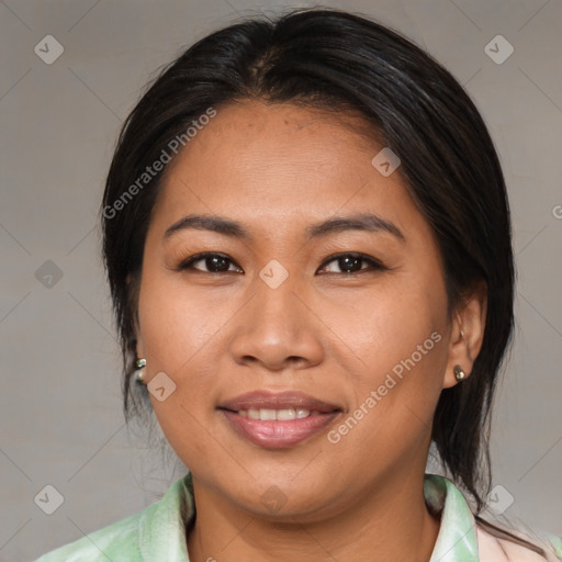 Joyful asian adult female with medium  brown hair and brown eyes