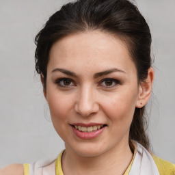 Joyful white young-adult female with medium  brown hair and brown eyes