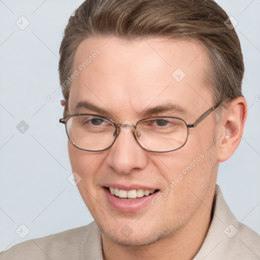 Joyful white adult male with short  brown hair and brown eyes