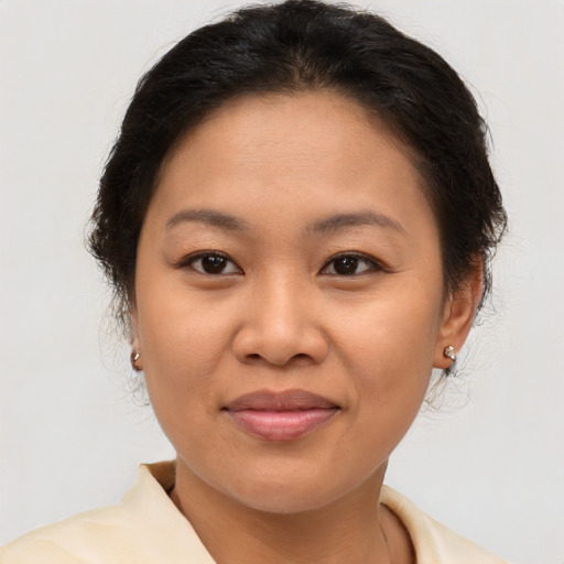 Joyful asian young-adult female with short  brown hair and brown eyes