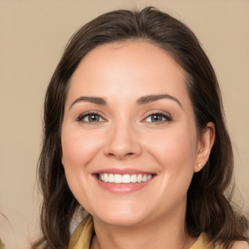 Joyful white young-adult female with medium  brown hair and brown eyes