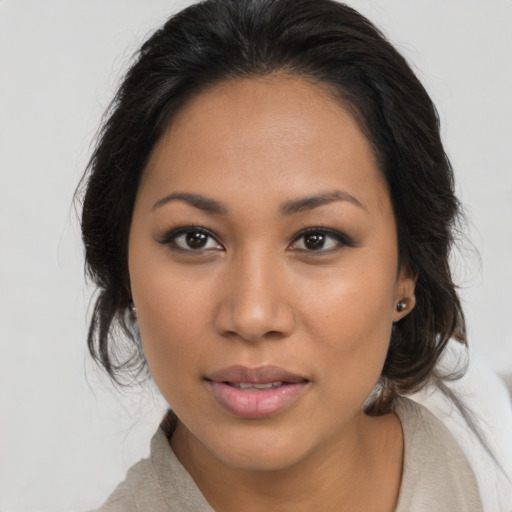 Joyful latino young-adult female with medium  brown hair and brown eyes