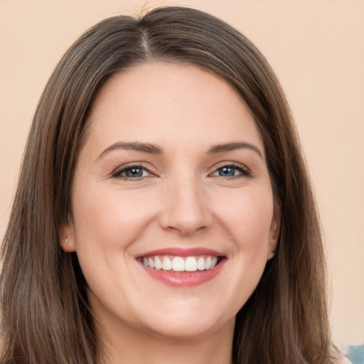 Joyful white young-adult female with long  brown hair and brown eyes