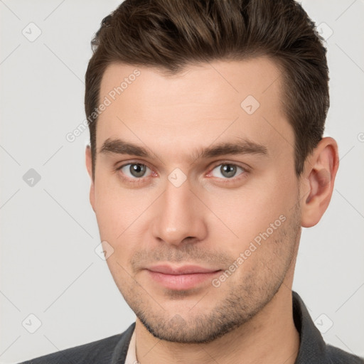 Joyful white young-adult male with short  brown hair and brown eyes