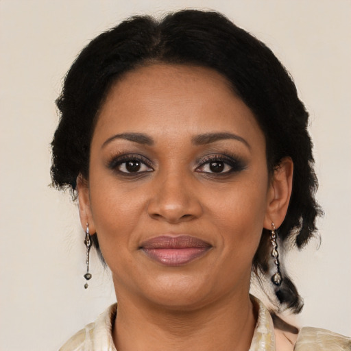 Joyful black adult female with medium  black hair and brown eyes