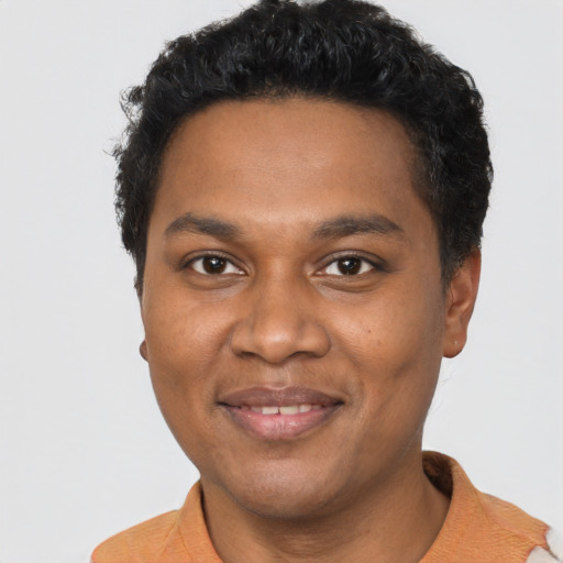 Joyful black young-adult male with short  black hair and brown eyes