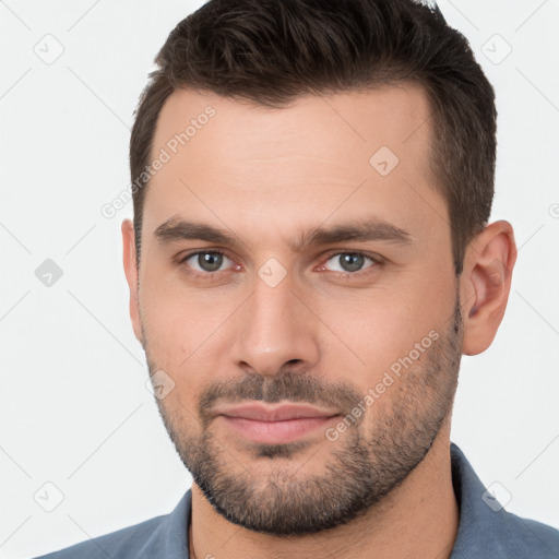 Joyful white young-adult male with short  brown hair and brown eyes