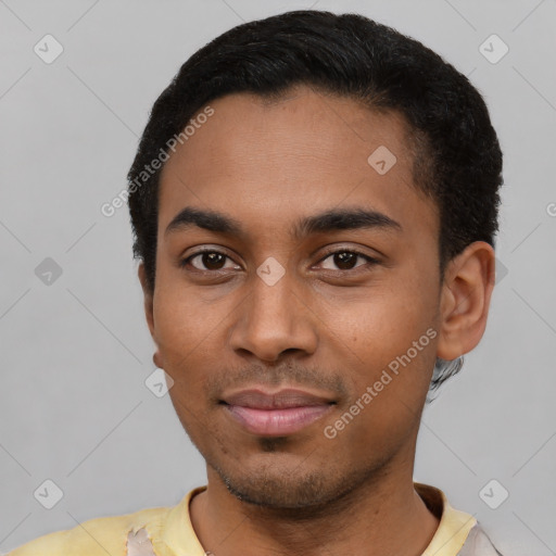 Joyful latino young-adult male with short  black hair and brown eyes