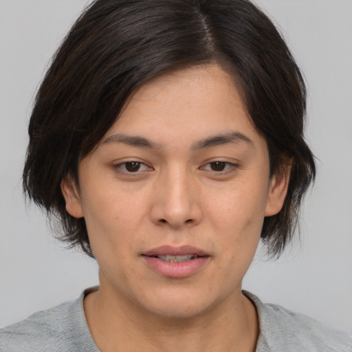 Joyful asian young-adult female with medium  brown hair and brown eyes