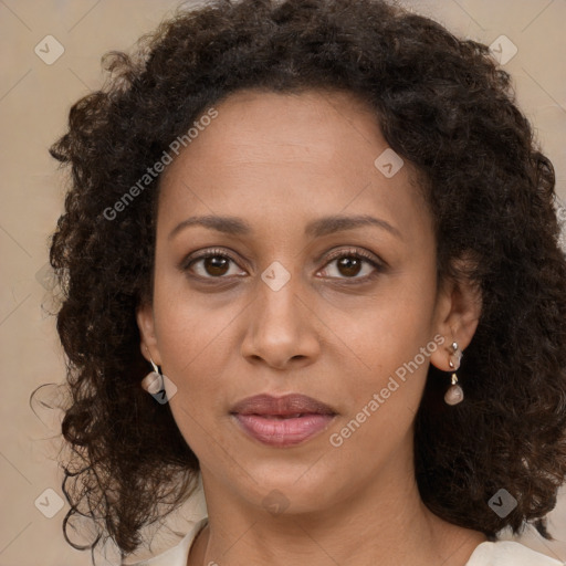 Joyful black young-adult female with long  brown hair and brown eyes