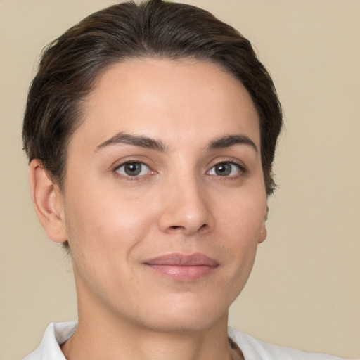 Joyful white young-adult female with short  brown hair and brown eyes