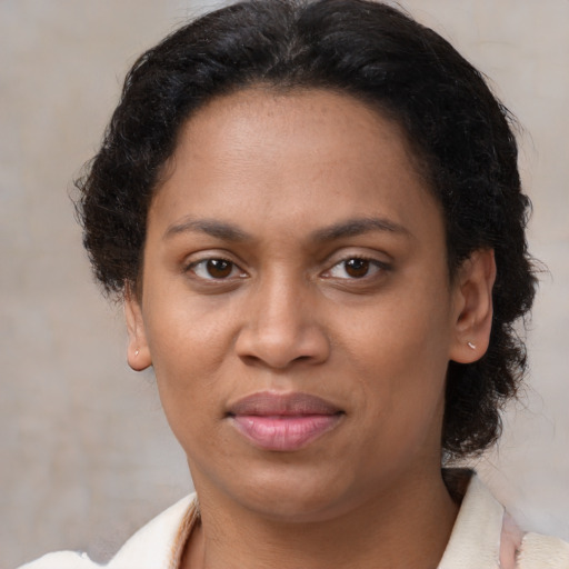 Joyful latino adult female with short  brown hair and brown eyes