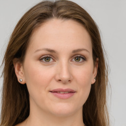 Joyful white young-adult female with long  brown hair and green eyes