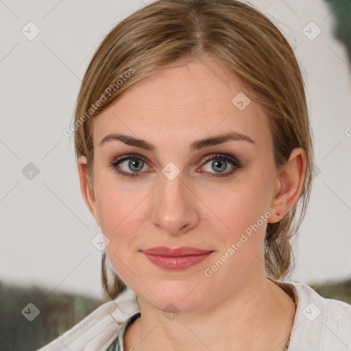 Joyful white young-adult female with medium  brown hair and blue eyes