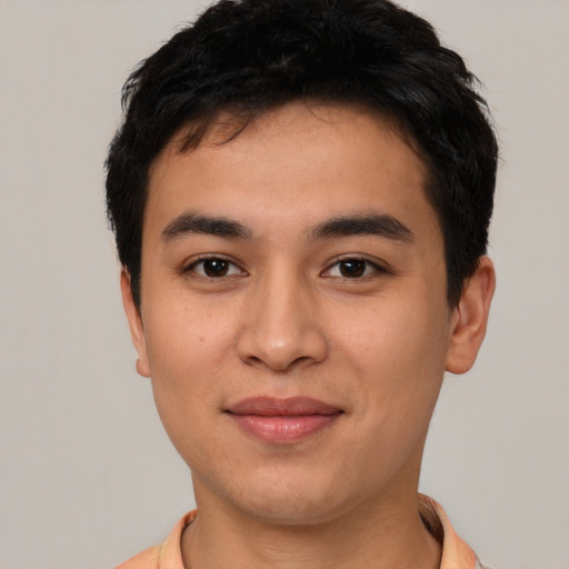 Joyful asian young-adult male with short  black hair and brown eyes