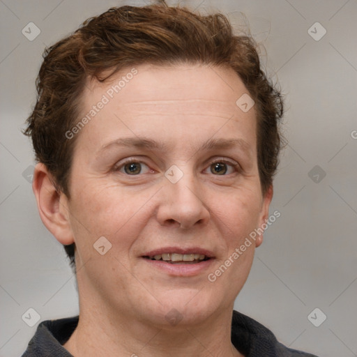 Joyful white adult female with short  brown hair and grey eyes