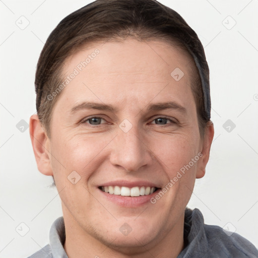 Joyful white young-adult female with short  brown hair and grey eyes