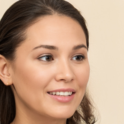 Joyful white young-adult female with long  brown hair and brown eyes