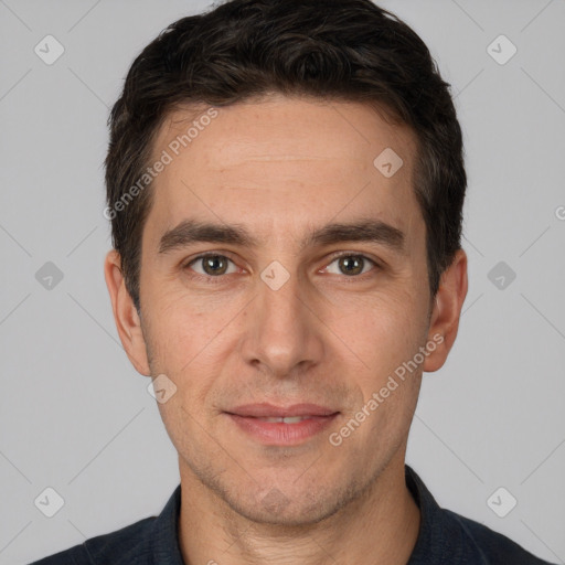 Joyful white adult male with short  brown hair and brown eyes