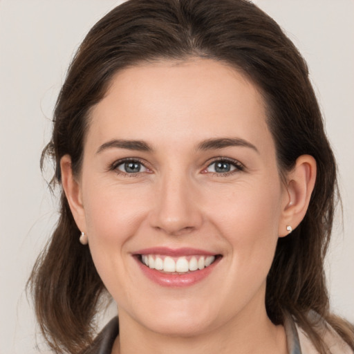 Joyful white young-adult female with medium  brown hair and brown eyes