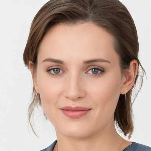 Joyful white young-adult female with medium  brown hair and grey eyes